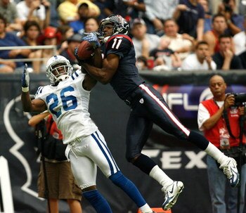 HOUSTON - SEPTEMBER 23:  Wide receiver Jerome Mathis #11 of the Houston Texans leaps for a reception over defensive back Kelvin Hayden #26 of the Indianapolis Colts in the third quarter  September 23, 2007 at Reliant Stadium in Houston, Texas.  (Photo by 