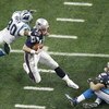 HOUSTON, TX - FEBRUARY 1:  Quarterback Tom Brady #12 of the New England Patriots is caught by safety Mike Minter #30 of the Carolina Panthers in the second quarter during Super Bowl XXXVIII at Reliant Stadium on February 1, 2004 in Houston, Texas. (Photo 