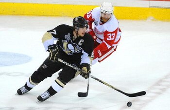 PITTSBURGH - JUNE 04:  Sidney Crosby #87 of the Pittsburgh Penguins controls the puck against Kris Draper #33 of the Detroit Red Wings during Game Four of the 2009 NHL Stanley Cup Finals on June 4, 2009 at Mellon Arena in Pittsburgh, Pennsylvania.  (Photo