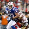 ORCHARD PARK, NY - NOVEMBER 30: Lee Evans #83  of the Buffalo Bills is tackled by Walt Harris #27 of the San Francisco 49ers  on November 30, 2008 at Ralph Wilson Stadium in Orchard Park, New York.  (Photo by Rick Stewart/Getty Images)