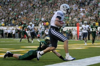 FORT COLLINS, CO - NOVEMBER 01:  Austin Collie #9 of the Brigham Young Cougars makes a touchdown reception in the final minute of the first half as Nick Oppenneer #11 of the Colorado State Rams is called for pass interference at Sonny Lubick Field at Hugh