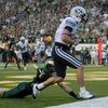 FORT COLLINS, CO - NOVEMBER 01:  Austin Collie #9 of the Brigham Young Cougars makes a touchdown reception in the final minute of the first half as Nick Oppenneer #11 of the Colorado State Rams is called for pass interference at Sonny Lubick Field at Hugh