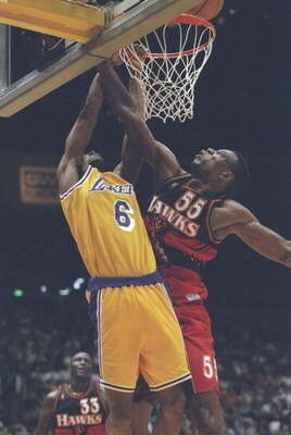 10 Nov 1996:  Guard Eddie Jones of the Los Angeles Lakers drives to the basket as center Dkembe Mutombo of the Atlanta Hawks tries to block him during a game at the Great Western Forum in Inglewood, California.  The Lakers won the game 92-85. Mandatory Cr