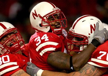 LINCOLN, NE - SEPTEMBER 15:  Cody Glenn #34 of the Nebraska Cornhuskers is congratulated by David Harvey #80 and Matt Slauson #70 after scoring a touchdown against the USC Trojans on September 15, 2007 at Memorial Stadium in Lincoln, Nebraska.  (Photo by 