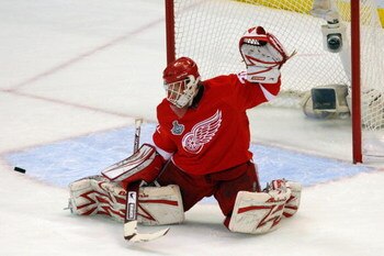DETROIT - JUNE 06:  Goaltender Chris Osgood #30 of the Detroit Red Wings saves a shot on goal by the Pittsburgh Penguins during Game Five of the 2009 NHL Stanley Cup Finals at Joe Louis Arena on June 6, 2009 in Detroit, Michigan.  (Photo by Jim McIsaac/Ge