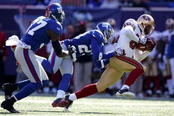 EAST RUTHERFORD, NJ - OCTOBER 19: Josh Morgan #84 of the San Francisco 49ers is tackled by Corey Webster #23 of the New York Giants on October 19, 2008 at Giant Stadium in East Rutherford, New Jersey.  (Photo by Chris Trotman/Getty Images)