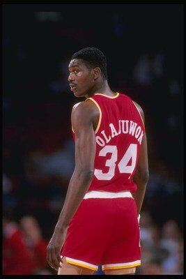 Center Hakeem Olajuwon of the Houston Rockets looks on.