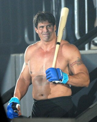 YOKOHAMA, JAPAN - MAY 26:  Former Oakland Athletics slugger Jose Canseco (L) walks to the ring with holding a bat prior to the match with Choi Hong-man at first Round of Super Hulk Tournament during Dream.9 at Yokohama Arena on May 26, 2009 in Yokohama, K