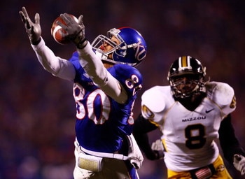 KANSAS CITY, MO - NOVEMBER 24:  Dezmon Briscoe #80 of the Kansas Jayhawks makes a catch as Justin Garrett #8 of the Missouri Tigers defends during the game at Arrowhead Stadium November 24, 2007 in Kansas City, Missouri.  (Photo by Jamie Squire/Getty Imag