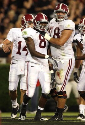 ATHENS, GA - SEPTEMBER 27:  Quarterback John Parker Wilson #14, offensiv lineman Mike Johnson #78 and wide receiver Julio Jones #8 of the Alabama Crimson Tide celebrate Jones' touchdown catch in the second quarter against the Georgia Bulldogs at Sanford S
