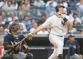 NEW YORK - JUNE 08:  Mark Teixeira #25 of the New York Yankees hits a solo home run in the first inning against the Tampa Bay Rays on June 8, 2009 at Yankee Stadium in the Bronx borough of New York City.  (Photo by Nick Laham/Getty Images)