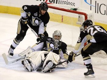 PITTSBURGH - JUNE 9:  Goaltender Marc-Andre Fleury #29 of the Pittsburgh Penguins makes a save against the Detroit Red Wings as Rob Scuderi #4 and Ruslan Fedotenko #26 help out during Game Six of the 2009 NHL Stanley Cup Finals at the Mellon Arena on June