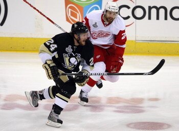 PITTSBURGH - JUNE 9:  Matt Cooke #24 of the Pittsburgh Penguins skates against Brad Stuart #23 of the Detroit Red Wings during Game Six of the 2009 NHL Stanley Cup Finals at the Mellon Arena on June 9, 2009 in Pittsburgh, Pennsylvania. The Penguins defeat
