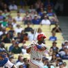 LOS ANGELES, CA - JUNE 06:  Jimmy Rollins #11 of the Philadelphia Phillies swings at a pitch and runs to first base during the game against the Los Angeles Dodgers at Dodger Stadium on June 6, 2009 in Los Angeles, California. The Dodgers defeated the Phil