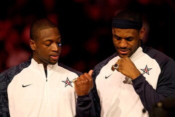 PHOENIX - FEBRUARY 15:  (L-R) Dwyane Wade and LeBron James, members of the gold medal winning USA Olympic basketball team, admire their rings during half time of the 58th NBA All-Star Game, part of 2009 NBA All-Star Weekend at US Airways Center on Februar