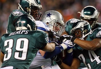 PHILADELPHIA - DECEMBER 28:  Akeem Jordan #56, Sheldon Brown #24 and Quintin Demps #39 of the Philadelphia Eagles tackle Jason Witten #82 of the Dallas Cowboys on December 28, 2008 at Lincoln Financial Field in Philadelphia, Pennsylvania. The Eagles defea