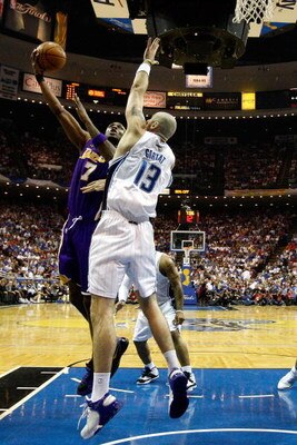 ORLANDO, FL - JUNE 11:  Lamar Odom #7 of the Los Angeles Lakers puts a shot up against Marcin Gortat #13 of the Orlando Magic in Game Four of the 2009 NBA Finals on June 11, 2009 at Amway Arena in Orlando, Florida.  NOTE TO USER:  User expressly acknowled