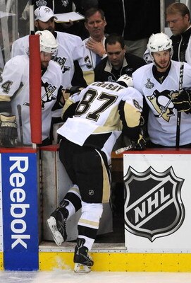 DETROIT - JUNE 12:  Sidney Crosby #87 of the Pittsburgh Penguins is helped off the ice after getting injured against the Detroit Red Wings during Game Seven of the 2009 NHL Stanley Cup Finals at Joe Louis Arena on June 12, 2009 in Detroit, Michigan.  (Pho