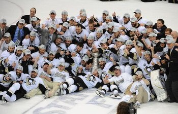 DETROIT - JUNE 12:  The Pittsburgh Penguins celebrate with the Stanley Cup after defeating the Detroit Red Wings by a score of 2-1 to win Game Seven and the 2009 NHL Stanley Cup Finals at Joe Louis Arena on June 12, 2009 in Detroit, Michigan.  (Photo by H