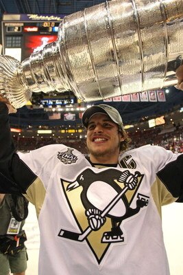 DETROIT - JUNE 12:  Sidney Crosby #87 of the Pittsburgh Penguins celebrates with the Stanley Cup after defeating the Detroit Red Wings by a score of 2-1 to win Game Seven and the 2009 NHL Stanley Cup Finals at Joe Louis Arena on June 12, 2009 in Detroit, 