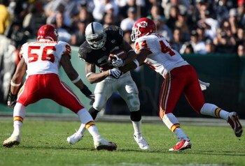OAKLAND, CA - NOVEMBER 30: Darren McFadden #20 of the Oakland Raiders runs against Derrick Johnson #56 and Jarrad Page #44 of the Kansas City Chiefs during an NFL game on November 30, 2008 at the Oakland-Alameda County Coliseum in Oakland, California. (Ph