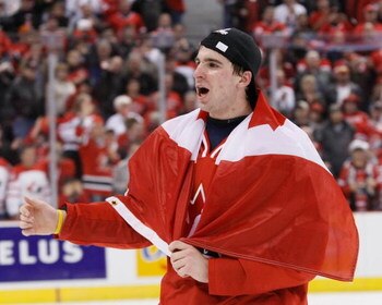 OTTAWA, ON - JANUARY 5:  John Tavares #19 of Team Canada skates with a Canadian flag wrapped around him during post game ceremonies after defeating Team Sweden at the Gold Medal Game of the IIHF World Junior Championships at Scotiabank Place on January 05