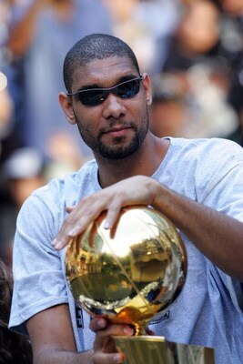 SAN ANTONIO - JUNE 17:  Tim Duncan of the San Antonio Spurs holds the Larry O'Brien trophy during the NBA championship parade down the San Antonio River walk June 17, 2007 in San Antonio, Texas. NOTE TO USER: User expressly acknowledges and agrees that, b