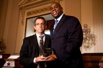 WASHINGTON - MAY 13: Kenneth Cole, chairman of the board of amfAR (The Foundation for AIDS Research), presents the amfAR Award of Courage to former basketball player Earvin 'Magic' Johnson (R) at a forum on HIV/AIDS on Capitol Hill on May 13, 2009 in Wash