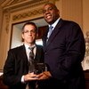 WASHINGTON - MAY 13: Kenneth Cole, chairman of the board of amfAR (The Foundation for AIDS Research), presents the amfAR Award of Courage to former basketball player Earvin 'Magic' Johnson (R) at a forum on HIV/AIDS on Capitol Hill on May 13, 2009 in Wash
