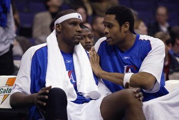 LOS ANGELES - JANUARY 15:  (L-R) Elton Brand #1 of the Los Angeles Clippers listens to Michael Olowokandi #34 while seated on the bench during the game against the Minnesota Timberwolves on January 15, 2003 at Staples Center in Los Angeles, California.  T