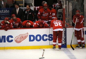 DETROIT - JUNE 12:  Brad Stuart #23, second from left, and Nicklas Lidstrom #5 of the Detroit Red Wings look on dejectedly after Game Seven of the 2009 NHL Stanley Cup Finals against the Pittsburgh Penguins at Joe Louis Arena on June 12, 2009 in Detroit, 