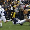 IOWA CITY, IA - NOVEMBER 8: Runningback Paki O'Meara #25 of the Iowa Hawkeyes is tackled by defenders Drew Astorino #28 of the Penn State Nittany Lions as teammate Kevin Kelly #23 and Jewel Hampton #27 of the Iowa Hawkeyes look on in the first quarter of 