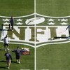 TAMPA, FL - JANUARY 31:  Workers paint the NFL logo on center field a day before Super Bowl XLIII between the Arizona Cardinals and the Pittsburgh Steelers on January 31, 2009 at Raymond James Stadium in Tampa, Florida.  (Photo by Win McNamee/Getty Images