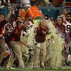 MIAMI - JANUARY 01:  Head coach Frank Beamer of the Virginia Tech Hokies gets gatorade dump on him by his players on their way to winning against the Cincinnati Bearcats during the FedEx Orange Bowl at Dolphin Stadium on January 1, 2009 in Miami, Florida.