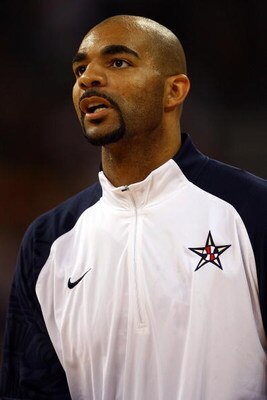 BEIJING - AUGUST 12:  Carlos Boozer #4 of the United States looks on during the US national anthem before taking on Angola during the men's preliminary round basketball game at the Beijing Olympic Basketball Gymnasium during Day 4 of the Beijing 2008 Olym