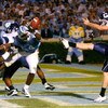CHAPEL HILL, NC - OCTOBER 04:  Punter Desi Cullen #13 of the Connecticut Huskies has his punt blocked for a touchdown by Bruce Carter #54 of the North Carolina Tar Heels during the game at Kenan Stadium on October 4, 2008 in Chapel Hill, North Carolina.  