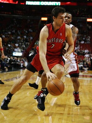 MIAMI - NOVEMBER 19:  Andrea Bargnani #7 of the Toronto Raptors drives past Daequan Cook #14 of the Miami Heat at American Airlines Arena on November 19, 2008 in Miami, Florida. The Raptors defeated the Heat 101-95. NOTE TO USER: User expressly acknowledg