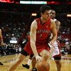 MIAMI - NOVEMBER 19:  Andrea Bargnani #7 of the Toronto Raptors drives past Daequan Cook #14 of the Miami Heat at American Airlines Arena on November 19, 2008 in Miami, Florida. The Raptors defeated the Heat 101-95. NOTE TO USER: User expressly acknowledg