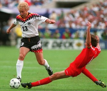 2 JUL 1994:   RUDY VOELLER OF GERMANY AVOIDS THE TACKLE OF GEORGES GRUN OF BELGIUM  DURING THE FIRST-HALF AT SOLDIER FIELD IN CHICAGO, ILLINOIS.  VOLLER SCORED TWO GOALS AND ASSISTED ON A THIRD AS GERMANY LED BELGIUM, 3-1 AT THE HALF. Mandatory Credit: Ch
