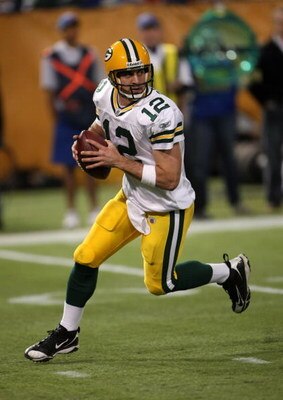 MINNEAPOLIS - NOVEMBER 09:  Quarterback Aaron Rodgers #12 of the Green Bay Packers drops back to pass against the Minnesota Vikings on November 9, 2008 at the Metrodome in Mineapolis, Minnesota.  The Vikings won 28-27.  (Photo by Stephen Dunn/Getty Images