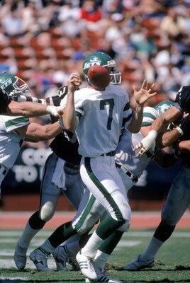 LOS ANGELES, CA - SEPTEMBER 8:  Quarterback Ken O'Brien #7 of the New York Jets has the ball knocked loose during a game against the Los Angeles Raiders at the Los Angeles Memorial Coliseum on September 8, 1985 in Los Angeles, California.  The Raiders won