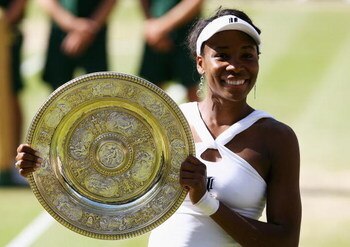 LONDON - JULY 05:  Venus Williams of United States celebrates winning the Championship trophy during the women's singles Final match against Serena Williams of United States on day twelve of the Wimbledon Lawn Tennis Championships at the All England Lawn 