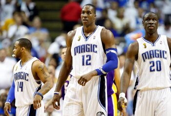 ORLANDO, FL - JUNE 14:  (C) Dwight Howard #12 of the Orlando Magic walks between teammates Jameer Nelson #14 and Mickael Pietrus #20 of the Magic in the second quarter of Game Five of the 2009 NBA Finals against the Los Angeles Lakers on June 14, 2009 at 