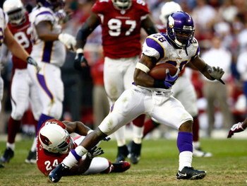 GLENDALE, AZ - DECEMBER 14:  Runningback Adrian Peterson #28 of the Minnesota Vikings breaks the tackle of Adrian Wilson #24 of the Arizona Cardinals during the game at the University of Phoenix Stadium on December 14, 2008 in Glendale, Arizona. The Vikin