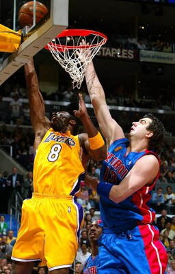 LOS ANGELES - JUNE 8:  Mehmet Okur #13 of the Detroit Pistons attempts to block Kobe Bryant #8 of the Los Angeles Lakers in the first half of Game 2 of the 2004 NBA Finals on June 8, 2004 at Staples Center in Los Angeles, California.  NOTE TO USER: User e