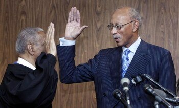 DETROIT - MAY 11:  Former Detroit Pistons' star Dave Bing (R) is sworn in as the 62nd mayor of city of Detroit by U.S. Court of Appeals Judge Damon Keith at the city�s Department of Elections office May 11, 2009 in Detroit, Michigan. Bing, a long-time Det