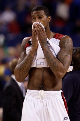 INDIANAPOLIS - MARCH 29:  Earl Clark #5 of the Louisville Cardinals covers his face with his jersey in the final minute of their 64-52 loss against the Michigan State Spartans during the fourth round of the NCAA Division I Men's Basketball Tournament at t