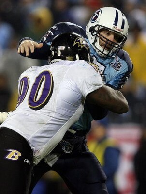 NASHVILLE, TN - JANUARY 10:  Quarterback Kerry Collins #5 of the Tennessee Titans is hit as he throws the ball by tackle Trevor Pryce #90 of the Baltimore Ravens during the AFC Divisional Playoff Game on January 10, 2009 at LP Field in Nashville, Tennesse