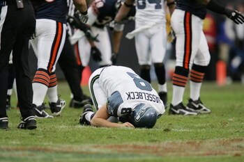 CHICAGO - JANUARY 14:  Quarterback Matt Hasselbeck #8 of the Seattle Seahawks lies on the field against the Chicago Bears during their NFC Divisional Playoff game on January 14, 2007 at Soldier Field in Chicago, Illinois.The Bears won 27-24 in overtime. (