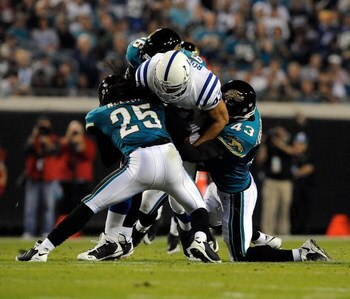 JACKSONVILLE, FL - DECEMBER 18:  Gijon Robinson #47 of the Indianapolis Colts is tackled by Reggie Nelson #25 and Gerald Sensabaugh #43 of the Jacksonville Jaguars during the game at Jacksonville Municipal Stadium on December 18, 2008 in Jacksonville, Flo